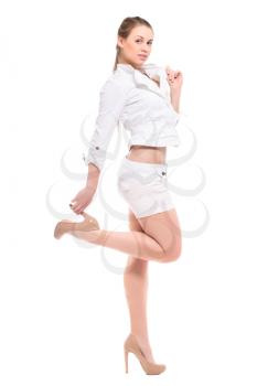 Playful young blond woman posing in white shirt and shorts. Isolated on white