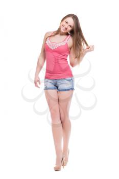 Laughing blond woman posing in pink shirt and denim shorts. Isolated on white