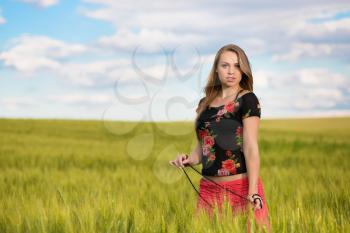 Seductive young woman posing on the wheat field