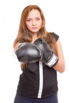 Young serious woman in black blouse posing with boxing gloves. Isolated