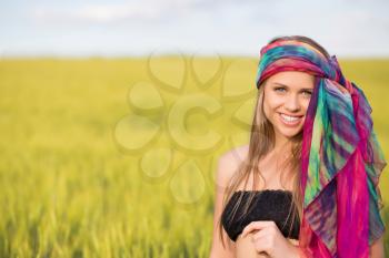 Smiling young woman posing in pareo outdoors