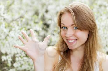 Portrait of joyful young blonde showing her hand