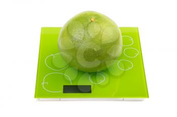 Sweetie fruit on square kitchen scales. Isolated