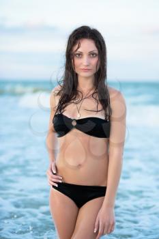 Stunning young brunette posing on the beach