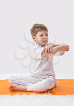 Royalty Free Photo of a Little Boy Doing Yoga