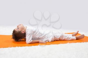 Royalty Free Photo of a Little Boy Doing Yoga