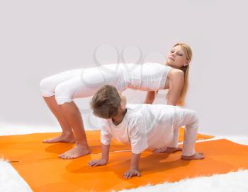 Royalty Free Photo of a Mother and Son Practicing Yoga