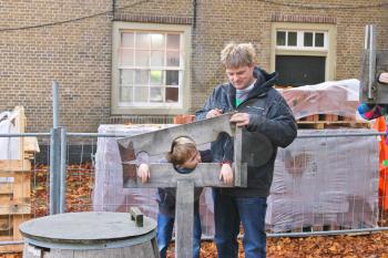 Father shows his son device pillory in the Dutch suburb. Netherlands