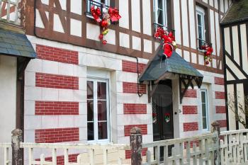 Celebratory Christmas decorations on the facade of  old french house