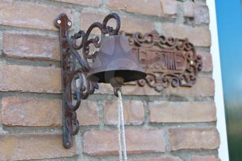 Old door bell on a brick wall at home