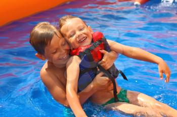 Two brothers in swimming pool at the water park