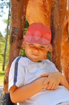 Smiling kid wearing a cap in the summer park