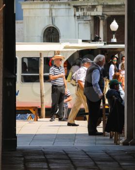 VENICE, ITALY - MAY 06, 2014: Tourists on quay of the Grand Canal in sunny spring day,Venice, Italy