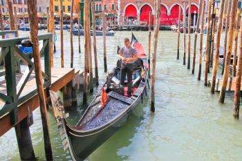 VENICE, ITALY - MAY 06, 2014: Gondolier in a gondola on the Grand Canal in Venice, Italy