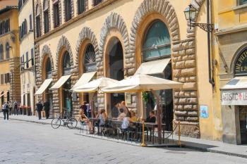 FLORENCE, ITALY - MAY 08, 2014: Tourists at an outdoor cafe in Florence. Italy 