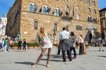 FLORENCE, ITALY - MAY 08, 2014: Tourists on the square in front of the Palazzo Vecchio. Florence, Italy 