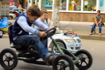 NIKOLAEV, UKRAINE - June 21, 2014: Kids in the play area riding a toy car