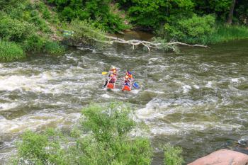 NIKOLAEV, VILLAGE GRUSHEVKA, UKRAINE - MAY 23, 2014: Rafting tourists with an experienced instructor on the river Southern Bug