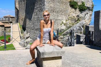 Attractive girl in the courtyard of fortresses Guaita on Mount Titan. The Republic of San Marino