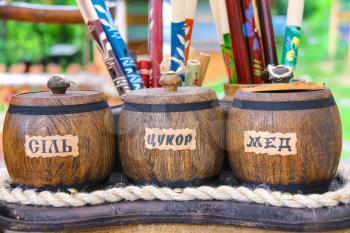 Village Urych , Lviv region. Ukraine - July 1, 2014 : Wooden pots labeled salt, sugar, honey.  Sale of souvenirs in the historical and cultural reserve Tustan