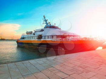 Ship at the port in the setting sun