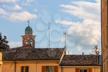 The bell tower above the city rooftops in centre of Rimini, Italy