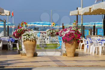 Decorative vases with flowers at the entrance to beach zone in Viareggio, Italy