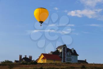 Yellow balloon in blue sky in Schodnica, Ukraine