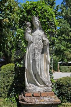 Old statue in the courtyard of Grazzano Visconti castle, Italy