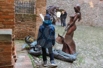 Vignola, Italy - October 30, 2016: Tourists near decorative sculptural installations in ancient fortress. Emilia-Romagna, Modena