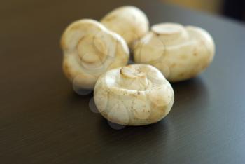 Fresh whole champignon vegetarian organic food. Mushroom meal closeup. Organic nutrition raw ingredients. 