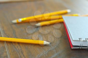 Drawing pencil with notebook on desk table working place. Idea memories reminder concept. Personal notepaper kit.