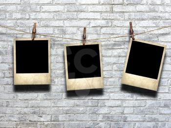 photo on rope with clothespins on a background of a brick wall