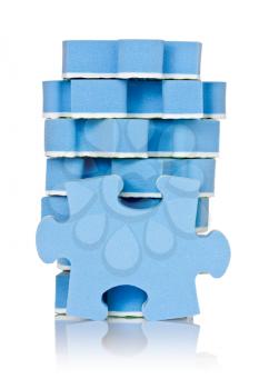 stack of blue puzzle over a white background