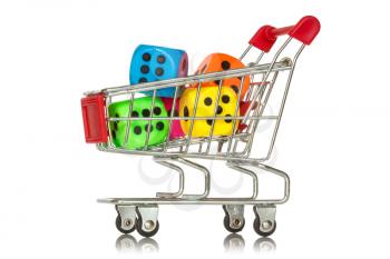 Buying games. Shopping cart with colorful dice inside. 