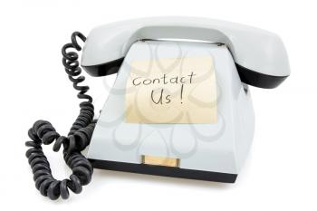 White telephone with sticky note Contact Us