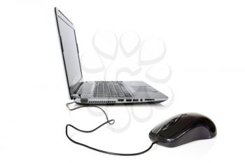 Laptop and mouse with selective focus on mouse. Isolated over a white background