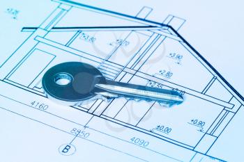 Closeup of key on blueprint of new home