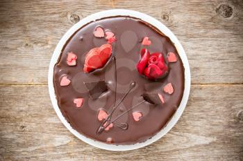 Chocolate cake decorated with sugar hearts and flower