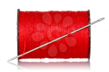 Spool of red thread with needle isolated on white background
