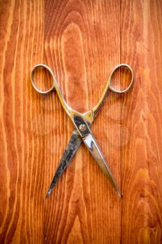 Vintage scissors on a wooden work table