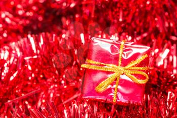 Christmas decoration with shiny tinsel and little gift box