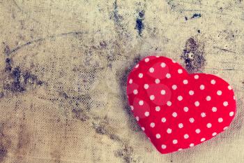 Red heart of polka dot fabric with copy-space on grunge background