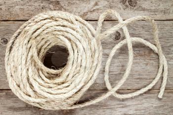 Roll of sisal rope on the wooden background
