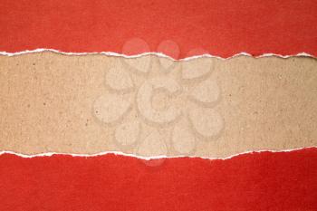 Torn red paper with a cardboard background for your text.