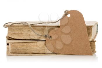 Two old books with heart shaped tag on the white background