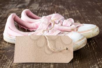  Kids canvas shoes with blank tag on a wooden background