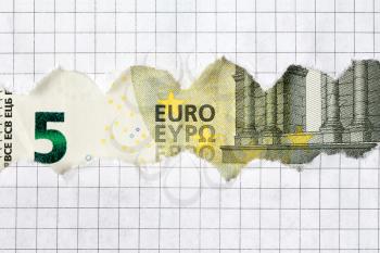 Five Euro bill in torn squared paper frame
