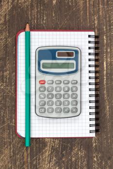 Digital calculator and spiral notebook with pencil.Top view.