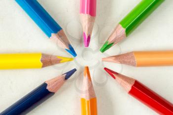 Close-up of a crayons circle on paper background